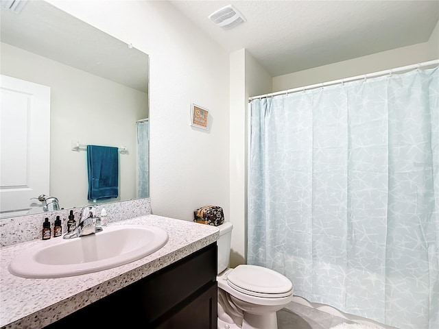 bathroom featuring toilet, tile flooring, and vanity