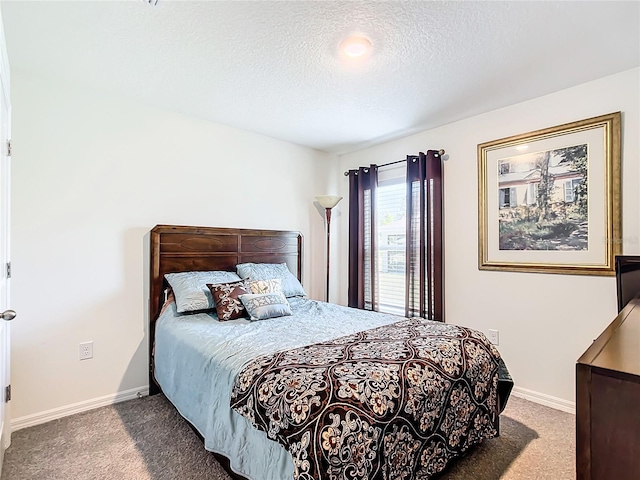 carpeted bedroom featuring a textured ceiling