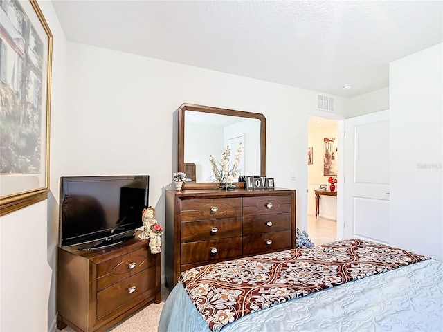 bedroom with light colored carpet