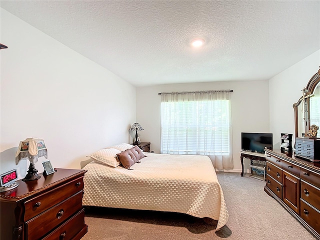 carpeted bedroom with a textured ceiling