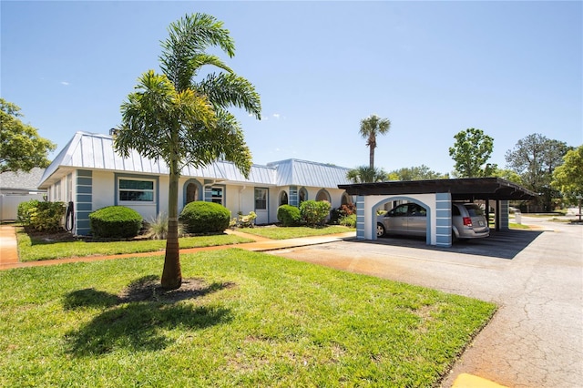 ranch-style house featuring a carport and a front lawn