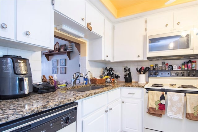 kitchen featuring white cabinetry, tasteful backsplash, white appliances, and sink