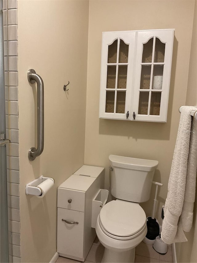 bathroom with toilet and tile patterned flooring