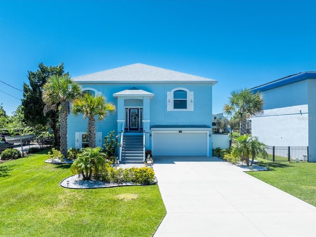 view of front of house featuring a front yard and a garage