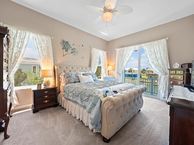 carpeted bedroom with ceiling fan, access to outside, and multiple windows