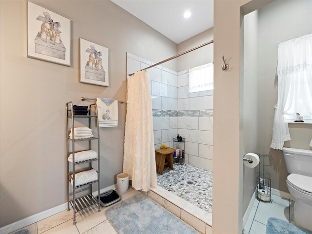 bathroom featuring walk in shower, tile floors, and toilet