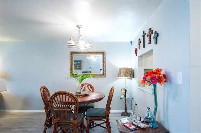 dining room with wood-type flooring and a notable chandelier