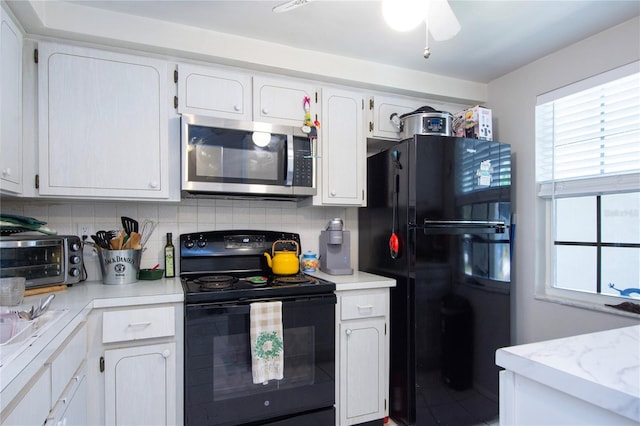 kitchen featuring backsplash, white cabinets, ceiling fan, and black appliances