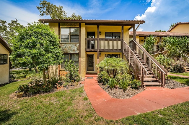 rear view of property featuring a lawn