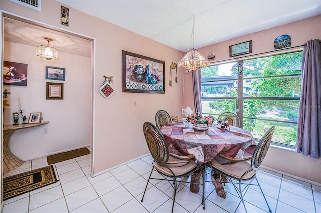 tiled dining area with a notable chandelier