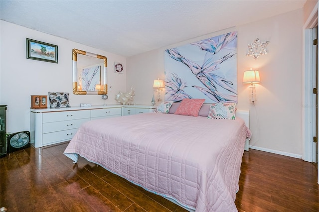 bedroom with dark hardwood / wood-style floors