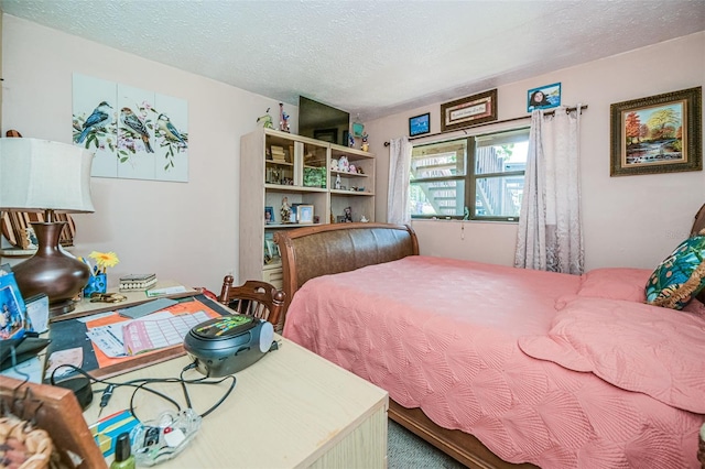 bedroom with carpet and a textured ceiling