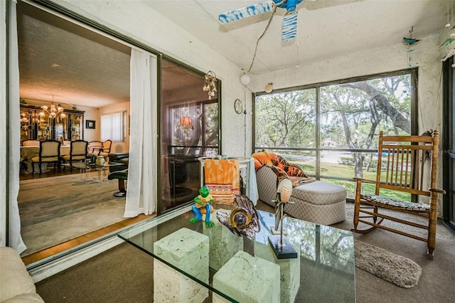 sunroom featuring a chandelier