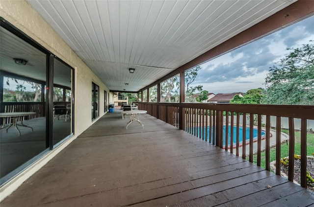 wooden terrace with a fenced in pool