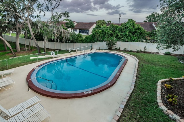 view of swimming pool with a patio area and a yard