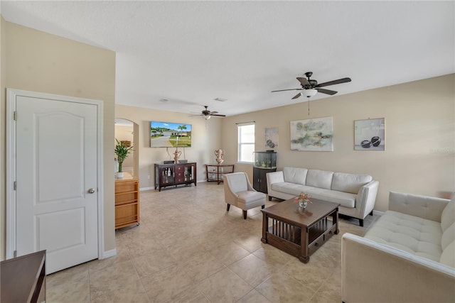 tiled living room featuring ceiling fan