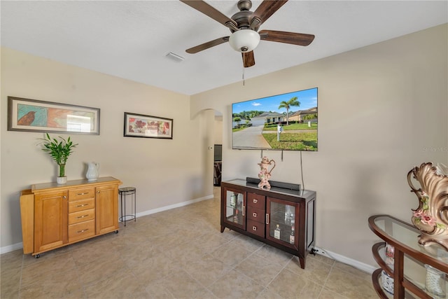 interior space featuring ceiling fan and light tile floors