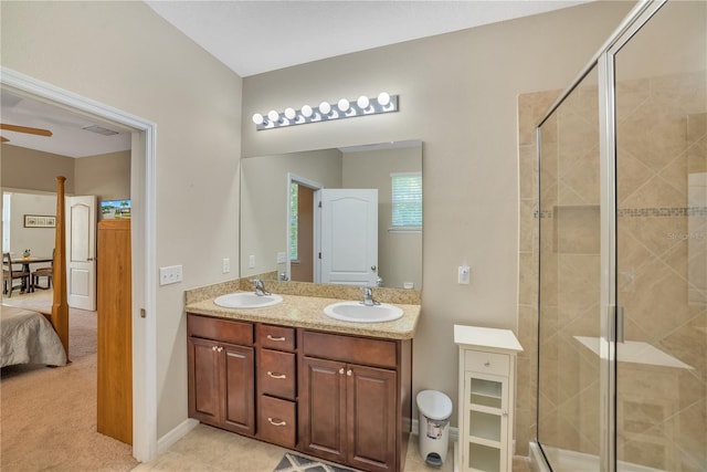 bathroom with tile flooring, dual vanity, and a shower with shower door