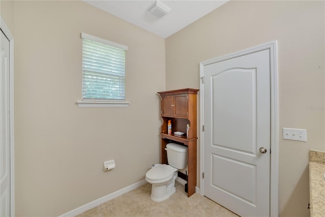 bathroom featuring tile floors and toilet