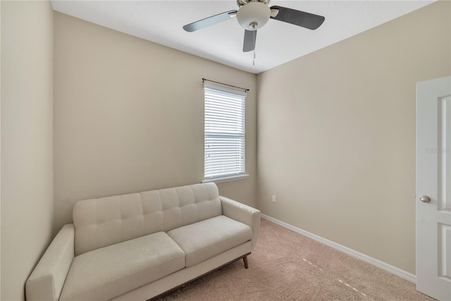 living area with ceiling fan and carpet