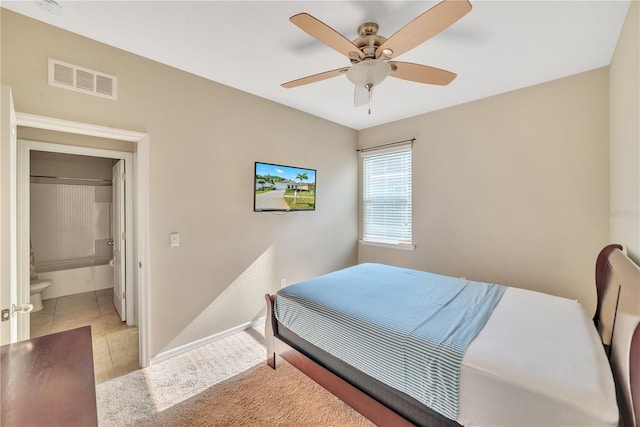 bedroom with tile flooring, connected bathroom, and ceiling fan