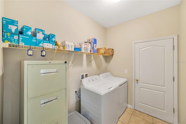 washroom with independent washer and dryer, light tile floors, and washer hookup