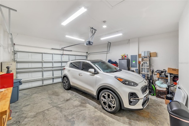 garage featuring a garage door opener and stainless steel fridge