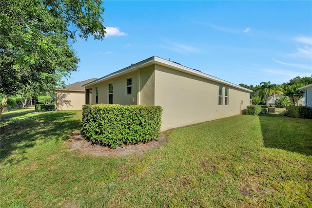 view of side of property with a lawn