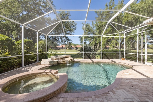 view of pool with pool water feature, a lanai, an in ground hot tub, and a patio