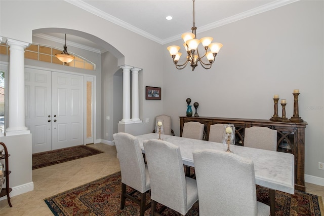 dining area with a notable chandelier, light tile patterned floors, and crown molding