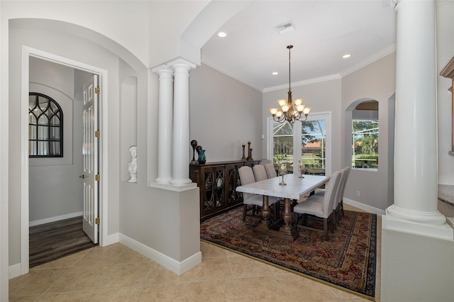 dining room with a chandelier, light tile patterned floors, and crown molding