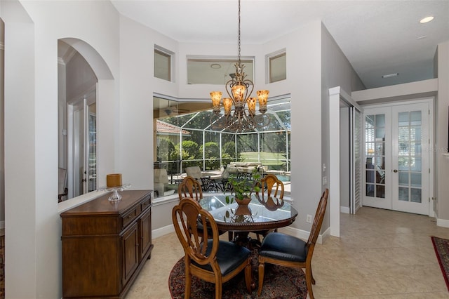 tiled dining area featuring french doors and a chandelier