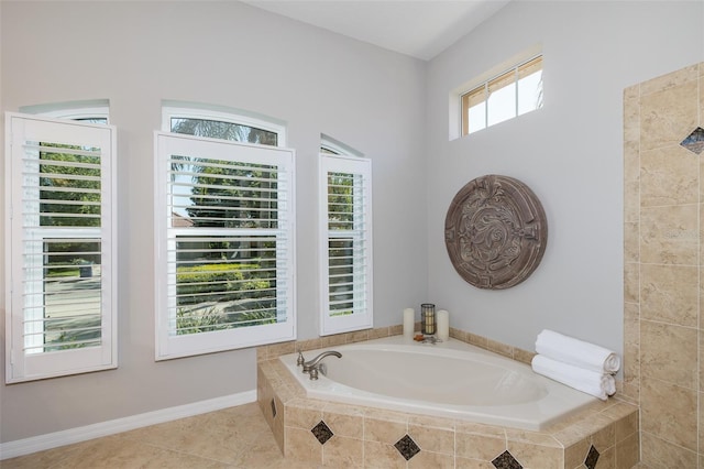 bathroom featuring tile patterned flooring, tiled bath, and a wealth of natural light