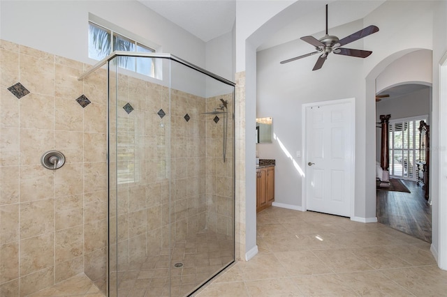 bathroom with an enclosed shower, vanity, tile patterned flooring, and ceiling fan