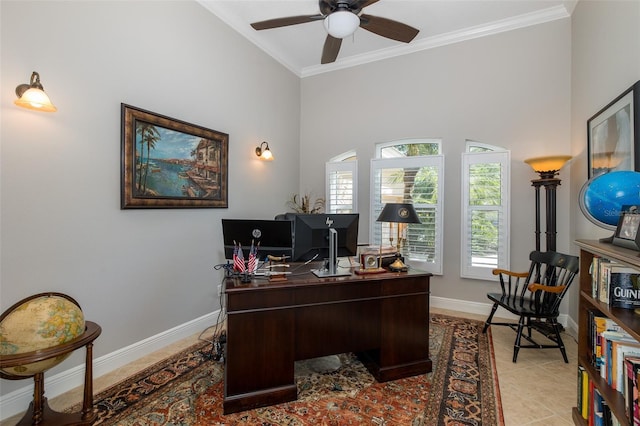 office space featuring ceiling fan, a towering ceiling, light tile patterned flooring, and ornamental molding