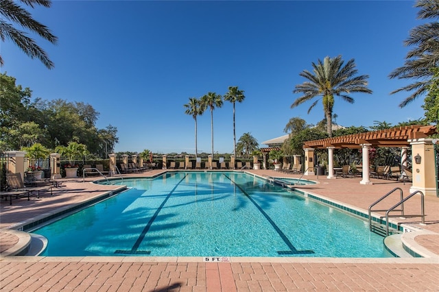 view of swimming pool with a pergola and a patio