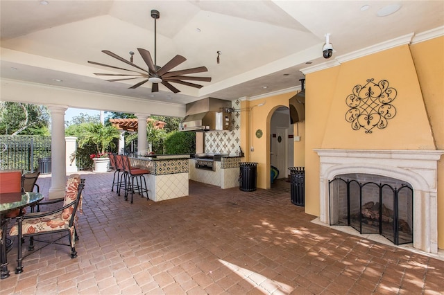 view of patio featuring ceiling fan and a bar