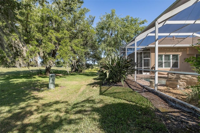 view of yard with glass enclosure