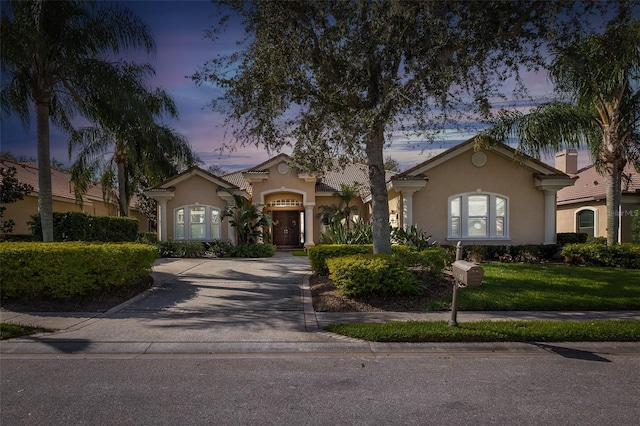 ranch-style home with a yard