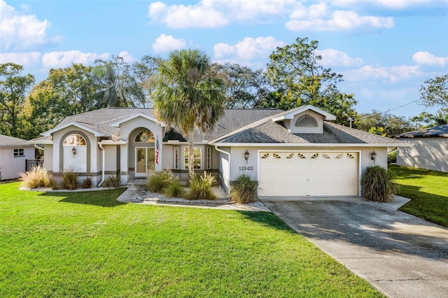 ranch-style home featuring a front lawn and a garage