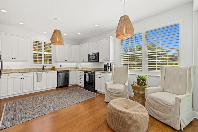 kitchen featuring a wealth of natural light, pendant lighting, and stainless steel appliances