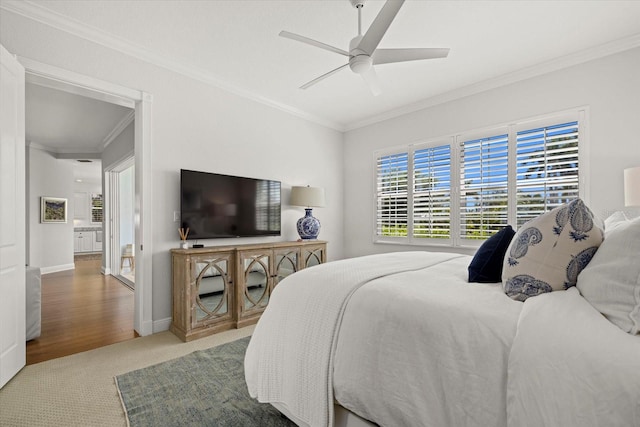 carpeted bedroom with ceiling fan and crown molding