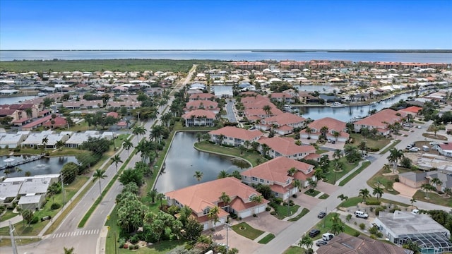 drone / aerial view with a residential view and a water view