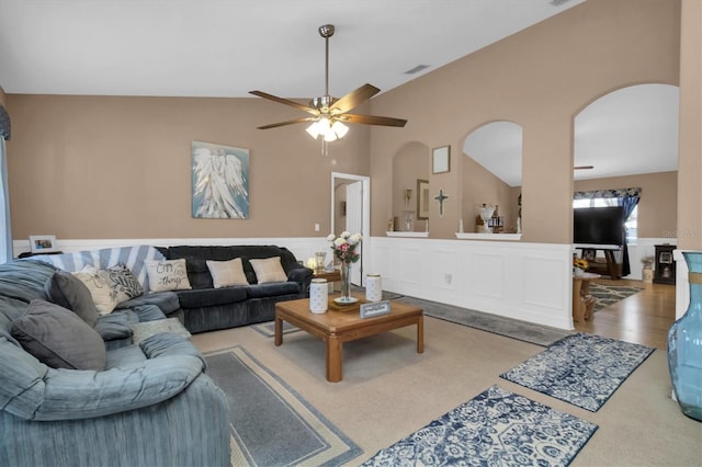 carpeted living room with high vaulted ceiling and ceiling fan