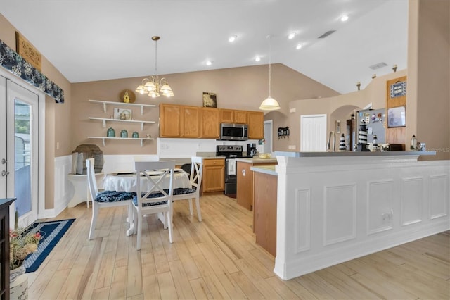 kitchen with stainless steel appliances, light wood-type flooring, and decorative light fixtures