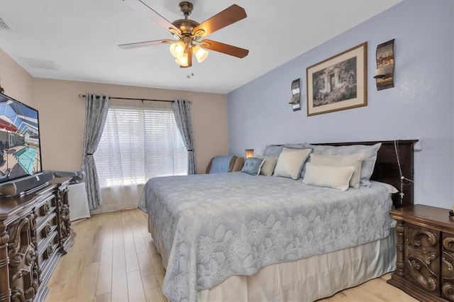 bedroom featuring light hardwood / wood-style floors and ceiling fan