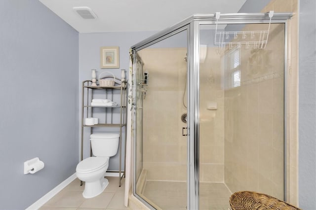 bathroom with a shower with door, toilet, and tile flooring