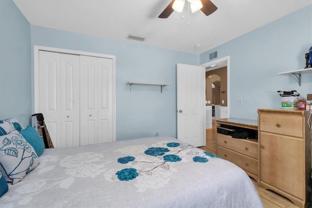 bedroom featuring a closet, ceiling fan, and light hardwood / wood-style floors