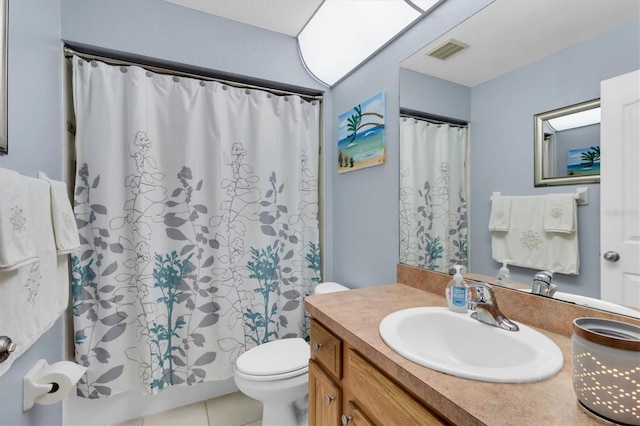 bathroom featuring toilet, tile flooring, and vanity