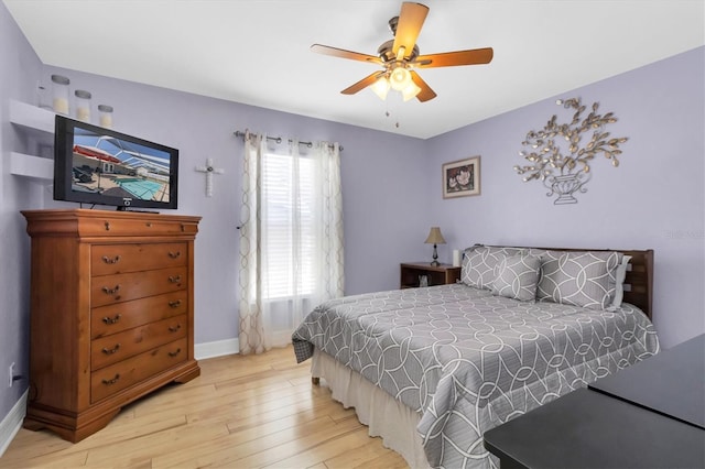 bedroom with light hardwood / wood-style flooring and ceiling fan